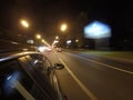The car is moving at high speed on the night road in the city. Royalty Free Stock Photo
