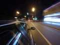 The car is moving at high speed on the night road in the city. Royalty Free Stock Photo