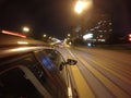 The car is moving at high speed on the night road in the city. Royalty Free Stock Photo