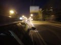 The car is moving at high speed on the night road in the city. Royalty Free Stock Photo