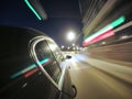 The car is moving at high speed on the night city road. Royalty Free Stock Photo