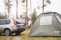 Car near touristic tent at cloudy and rainy day. Rural scene Royalty Free Stock Photo