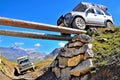 Car off roading over tree trunk bridge across a gab in the Alp mountain..20/08/2010 - Val d`Isere, France