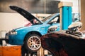 Car with opened bonnet in repair workshop Royalty Free Stock Photo