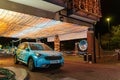 A car outside the 'Daft As a Brush' cancer patient transport charity's building, lit up