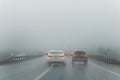 Car overtake rules violation crossing double lane. traffic on foggy misty rainy highway intercity road low poor