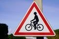 Car overtakes cyclist bicycle warning sign road danger