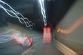 Car overtakes truck inside the highway tunnel. Wavy light trails effect in color. Royalty Free Stock Photo