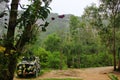 the car is painted a khaki color in the Vietnamese jungle