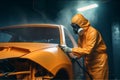 Car painter in protective clothes and mask painting a car, mechanic using a paint spray gun in a painting chamber. Bodywork, paint