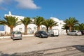 Car park in font of white, typical building, Thira, Santorini, Greece