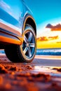 A car parked on a beach next to the ocean at sunset Royalty Free Stock Photo