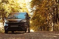 Car parked on country road near autumn fores Royalty Free Stock Photo