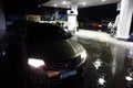 A car is parked at a gasoline refilling station on a rainy night Royalty Free Stock Photo