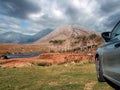 Car parked on the grass with view on Twelve pines island, county Galway, Ireland. Fantastic Irish landscape in the background