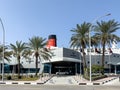 Car parked at the hotel entrance with Queen Elizabeth 2 ship in the background. Royalty Free Stock Photo