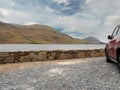 Car parked by a lake with beautiful view on a mountains. Connemara National park, County Galway, Ireland Royalty Free Stock Photo