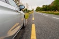 Car parked off the small country road. Selective focus. Nobody.