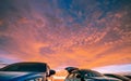 Car parked at outdoor car parking lot of campsite with beautiful sunset sky. Car drive for adventure road trip. Nature landscape.