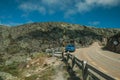 Car parked in the roadside on rocky landscape