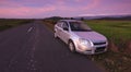 Car parked on roadside at sunset in a rural area Royalty Free Stock Photo