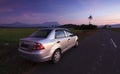 Car parked on roadside at sunset in a rural area Royalty Free Stock Photo