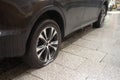 A car parked on the sidewalk with both tires flat. Bandalism in the streets