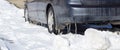 Car parked in the snow with icicles