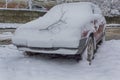 Car parked in the yard covered with snow Royalty Free Stock Photo