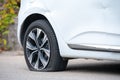 Car is in parking of accident punctured wheel, dented door, scratches on fender Royalty Free Stock Photo