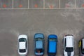 Car parking aerial top view. Occupied and vacant lots with vehicles. Park marked area of modern urban structure. City landscape