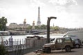 Car parking, barge and Alexander the Third Bridge on the background of the Eiffel Tower in Paris Royalty Free Stock Photo