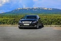 Car in the parking lot in front of a mountain range