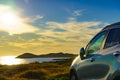 Car parking on seashore in sunset time Royalty Free Stock Photo