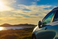 Car parking on seashore in sunset time Royalty Free Stock Photo