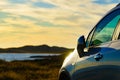 Car parking on seashore in sunset time Royalty Free Stock Photo