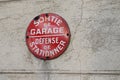 Car parking sign prohibited on building wall means in french defense de stationner sortie de garage means no parking cars can