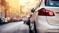 Car parking on the street. Modern white car close-up red headlights banner background. Royalty Free Stock Photo