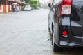 Car parking on the street of village while raining and show leve Royalty Free Stock Photo