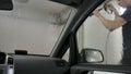 Car passing through the car wash, a person washes the car with a non-contact sink, a view from inside the car