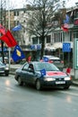 Car passing by with movement blur, wearing Flags of Kosovo and Albanian flags in Prishtina to celebrate Kosovo Independence