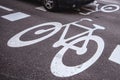 Car passing over bicycle lane sign on the road Royalty Free Stock Photo