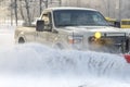 Car pickup cleaned from snow by a snowplough during wintertime