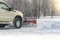 Car pickup cleaned from snow by a snowplough during wintertime