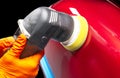 Car polish wax worker hands applying protective tape before polishing. Buffing and polishing car. Car detailing. Man holds a polis Royalty Free Stock Photo