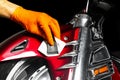 Car polish wax worker hands applying protective tape before polishing. Buffing and polishing motorcycle. Car detailing. Man holds Royalty Free Stock Photo
