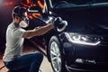 Car polish wax. worker hands holding a polisher Royalty Free Stock Photo