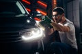 Car polish wax. worker hands holding a polisher Royalty Free Stock Photo