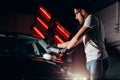 Car polish wax. worker hands holding a polisher Royalty Free Stock Photo