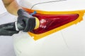 Car polish wax worker hands holding polisher and polish. Close up at hand holding car polisher. Man holds a polisher in the hand a Royalty Free Stock Photo